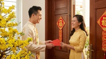 Khoảnh khắc gia chủ tuổi Dậu chọn người xông đất năm 2027 mang theo lộc xuân và bao lì xì đỏ bước vào cửa chính