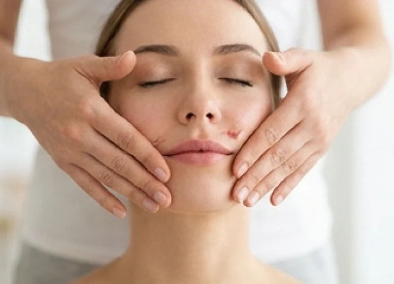 Động tác dùng hai ngón tay vuốt ngược cơ má để khắc phục tình trạng xệ khóe miệng