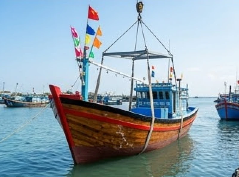 Chiếc ghe gỗ mới đóng với lớp sơn bóng bẩy đang thực hiện nghi thức chạm nước lần đầu tiên