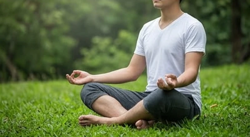 Mơ thấy đi thuyền điềm gì: Giải mã tâm lý & con số may mắn 6 Một người nhắm mắt thư giãn và ngồi thiền tĩnh tâm trên thảm cỏ xanh mướt để xoa dịu áp lực tâm lý