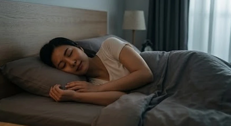 Một người phụ nữ đang nằm nghiêng thư giãn trong căn phòng ngủ thông thoáng và ánh sáng ấm