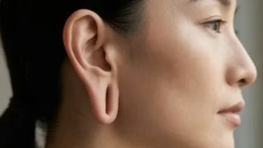 Cận cảnh góc nghiêng khuôn mặt người sở hữu tướng tai Phật với dái tai dày dặn rủ xuống và vành tai cao ngang chân mày